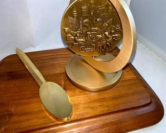 Lot 5146. $48.00  Desk Accessories; Gold Tone letter opener, gold tone Kleenex holder,  Chicago spinning medallion on a wood base, and a Cross ballpoint pen with brass stand. 