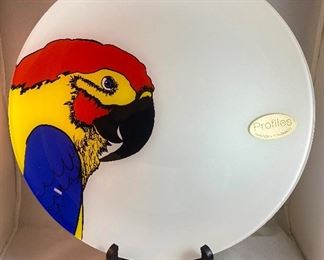 Lot 5152. $27.00  Lenox Birds of America Tea Cup and Saucers 1 Goldfinch and 1 Blue Jay (both issued 1993) and a Profiles Parrot Art Glass Plate 13" Diameter.