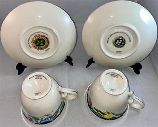 Lot 5152. $27.00  Lenox Birds of America Tea Cup and Saucers 1 Goldfinch and 1 Blue Jay (both issued 1993) and a Profiles Parrot Art Glass Plate 13" Diameter.