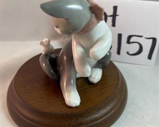 Lot 5157.  $115.00. A lovely Lladro lot includes a 1985- Lladro Collectors Society Don Quixote Plaque (6"wx4"h) with a shell design on the back. 1984 Lladro Cat 'n Mouse (2.5"hx3"w) figurine, and a Porcelain "Nosegay" 4.5" x 2"h. Little wooden stand not included. 