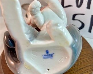 Lot 5157.  $115.00. A lovely Lladro lot includes a 1985- Lladro Collectors Society Don Quixote Plaque (6"wx4"h) with a shell design on the back. 1984 Lladro Cat 'n Mouse (2.5"hx3"w) figurine, and a Porcelain "Nosegay" 4.5" x 2"h. Little wooden stand not included. 