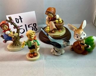 Lot 5158. $56.00. Interesting Lot of 5 Hummel and Goebel Figures. Hummel "Chick Girl" 3.5"h x 3"w. Hummel "Apple Tree Girl" 3.5"h x 2.5"w. Hummel Boy with Hen 3"h x 2"w. Goebel Bluebird, and Vintage Goebel Bunny Painting Egg 4-827 (1979-1991) 3.5"h x 3"w. Wooden stand not included. 