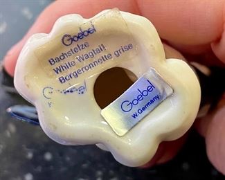 Lot 5158. $56.00. Interesting Lot of 5 Hummel and Goebel Figures. Hummel "Chick Girl" 3.5"h x 3"w. Hummel "Apple Tree Girl" 3.5"h x 2.5"w. Hummel Boy with Hen 3"h x 2"w. Goebel Bluebird, and Vintage Goebel Bunny Painting Egg 4-827 (1979-1991) 3.5"h x 3"w. Wooden stand not included. 