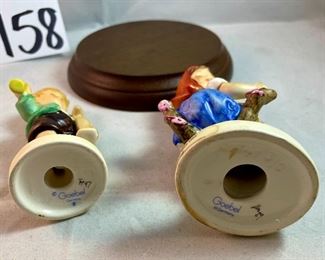 Lot 5158. $56.00. Interesting Lot of 5 Hummel and Goebel Figures. Hummel "Chick Girl" 3.5"h x 3"w. Hummel "Apple Tree Girl" 3.5"h x 2.5"w. Hummel Boy with Hen 3"h x 2"w. Goebel Bluebird, and Vintage Goebel Bunny Painting Egg 4-827 (1979-1991) 3.5"h x 3"w. Wooden stand not included. 