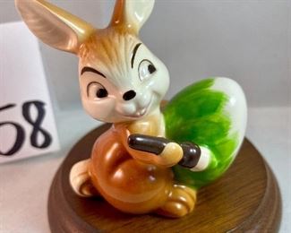 Lot 5158. $56.00. Interesting Lot of 5 Hummel and Goebel Figures. Hummel "Chick Girl" 3.5"h x 3"w. Hummel "Apple Tree Girl" 3.5"h x 2.5"w. Hummel Boy with Hen 3"h x 2"w. Goebel Bluebird, and Vintage Goebel Bunny Painting Egg 4-827 (1979-1991) 3.5"h x 3"w. Wooden stand not included. 