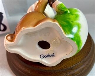 Lot 5158. $56.00. Interesting Lot of 5 Hummel and Goebel Figures. Hummel "Chick Girl" 3.5"h x 3"w. Hummel "Apple Tree Girl" 3.5"h x 2.5"w. Hummel Boy with Hen 3"h x 2"w. Goebel Bluebird, and Vintage Goebel Bunny Painting Egg 4-827 (1979-1991) 3.5"h x 3"w. Wooden stand not included. 