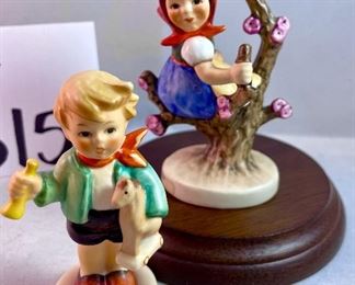 Lot 5158. $56.00. Interesting Lot of 5 Hummel and Goebel Figures. Hummel "Chick Girl" 3.5"h x 3"w. Hummel "Apple Tree Girl" 3.5"h x 2.5"w. Hummel Boy with Hen 3"h x 2"w. Goebel Bluebird, and Vintage Goebel Bunny Painting Egg 4-827 (1979-1991) 3.5"h x 3"w. Wooden stand not included. 