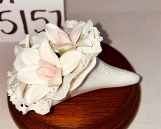 Lot 5157.  $115.00. A lovely Lladro lot includes a 1985- Lladro Collectors Society Don Quixote Plaque (6"wx4"h) with a shell design on the back. 1984 Lladro Cat 'n Mouse (2.5"hx3"w) figurine, and a Porcelain "Nosegay" 4.5" x 2"h. Little wooden stand not included. 