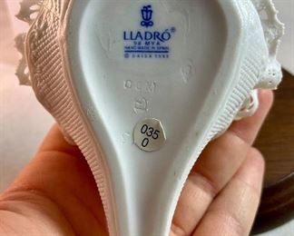 Lot 5157.  $115.00. A lovely Lladro lot includes a 1985- Lladro Collectors Society Don Quixote Plaque (6"wx4"h) with a shell design on the back. 1984 Lladro Cat 'n Mouse (2.5"hx3"w) figurine, and a Porcelain "Nosegay" 4.5" x 2"h. Little wooden stand not included. 