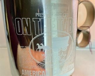 Lot 5161.  $27.00. "You cannot roller skate in a buffalo herd..." but you can own a carved buffalo horn bird on a branch! We will include this pewter Buffalo incased in glass and a metal western cup. 