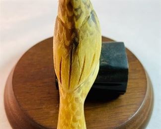 Lot 5161.  $27.00. "You cannot roller skate in a buffalo herd..." but you can own a carved buffalo horn bird on a branch! We will include this pewter Buffalo incased in glass and a metal western cup. 