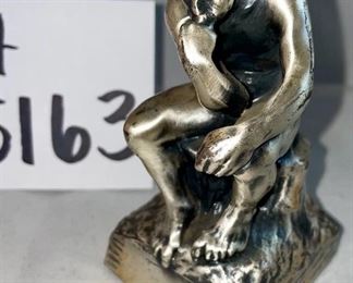 Lot 5163. $60.00  Bronze Old World Gnome figure with his head between his knees and his hands holding his face!  4.5"x4"h, and he is heavy.  Next is a metal replica of Rodan's "The Thinker."   He seems to be contemplating nature from another time and place.  4.5"h x 2.25"w. 