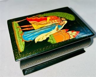 Lot 5165. $95.00. Bjorn Wiinblad for Rosenthal's studio-linie, made in Germany covered porcelain jar "Scenes from a Window" series. Covered box with a Dutch inscription on the back. Two black lacquered hinged boxes (2.75"l x 2"w)