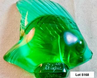 Lot 5168. $125.00. This lot includes 3 Lalique Paris Angel Fish. The fish are in Peach, Teal, and Pink w/3 small mirrored discs. Also included are 3 suede Lalique drawstring bags and only 2 Lalique boxes. The wooden stand isn't included. 