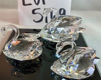 Lot 5169. $70.00. Lot of 3 signature Swarovski crystal swans. No box, need to be cleaned. Largest: 1.5"h x 1.75"w x 3"d, two smaller: 1.25"h x 1.25"w x 2"d