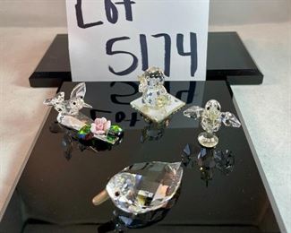 Lot 5174. $36.00. A lot of Crystal Miniatures. 1)Crystal Zoo duck w/pewter bill (has been repaired), 2)Crystal caravan hummingbird 1.5"h. 3)Faceted Bird in mirror base 1"tall. 4)crystal hummingbird w/porcelain flower 2"l x 1"h unmarked