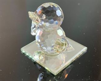 Lot 5174. $36.00. A lot of Crystal Miniatures. 1)Crystal Zoo duck w/pewter bill (has been repaired), 2)Crystal caravan hummingbird 1.5"h. 3)Faceted Bird in mirror base 1"tall. 4)crystal hummingbird w/porcelain flower 2"l x 1"h unmarked