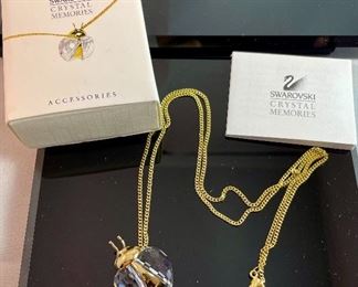 Lot 5172. $40.00. Swarovski Crystal Memories Lady Bug necklace and 2 fun crystal spiders.  The necklace comes in a gift box and has a Swarovski Branded 20" chain