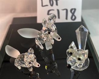Lot 5178. $43.00. 3 crystal foxes. The Large and Small fox from Crystal Zoo by Swarovski have frosted tails and snouts, both are signed. The 3rd fox looks a little down but is made of faceted crystals on a base (2"h) 