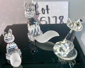 Lot 5178. $43.00. 3 crystal foxes. The Large and Small fox from Crystal Zoo by Swarovski have frosted tails and snouts, both are signed. The 3rd fox looks a little down but is made of faceted crystals on a base (2"h) 