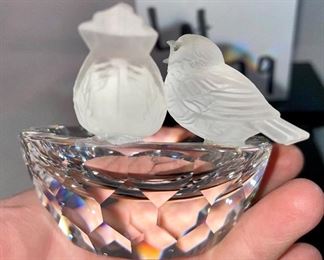 Lot 5179. $28.00. Swarovski Crystal Zoo Cat closely watching 2 birds on a birdbath (one of the birds was reattached to piece). Cat is 2.75"h x 1"w with a flexible tail.  Bird Bath: 2/5"h x 3"w. Both pieces are signed. Sold as-is.
