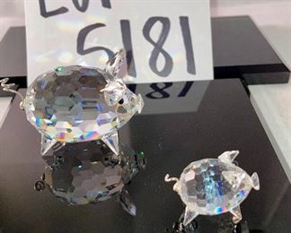 Lot 5181. $90.00. Piggies, puppies, and a kitty. Mama Pig (1.5"w x 2"lx1"h) and piglet (1") from Swarovski Crystal Zoo (look at their cute tails). 2 pups one on an oval base and one lounging. The lounger is signed by Swarovski. The kitty is signed by Crystal Zoo and 1.5"h x .75"w. 