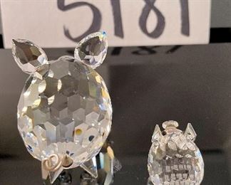 Lot 5181. $90.00. Piggies, puppies, and a kitty. Mama Pig (1.5"w x 2"lx1"h) and piglet (1") from Swarovski Crystal Zoo (look at their cute tails). 2 pups one on an oval base and one lounging. The lounger is signed by Swarovski. The kitty is signed by Crystal Zoo and 1.5"h x .75"w. 