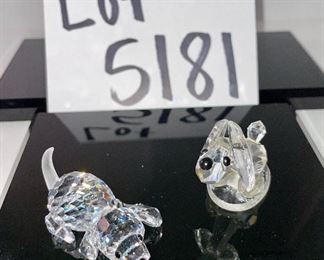 Lot 5181. $90.00. Piggies, puppies, and a kitty. Mama Pig (1.5"w x 2"lx1"h) and piglet (1") from Swarovski Crystal Zoo (look at their cute tails). 2 pups one on an oval base and one lounging. The lounger is signed by Swarovski. The kitty is signed by Crystal Zoo and 1.5"h x .75"w. 