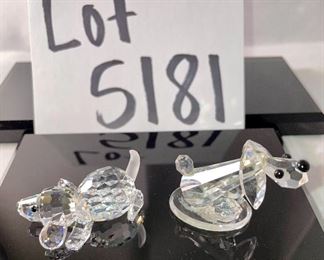 Lot 5181. $90.00. Piggies, puppies, and a kitty. Mama Pig (1.5"w x 2"lx1"h) and piglet (1") from Swarovski Crystal Zoo (look at their cute tails). 2 pups one on an oval base and one lounging. The lounger is signed by Swarovski. The kitty is signed by Crystal Zoo and 1.5"h x .75"w. 
