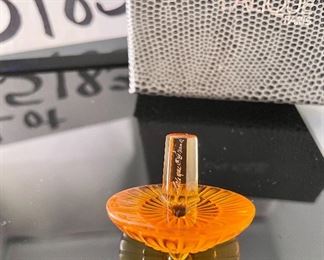 Lot 5183. $70.00ea.  Oh la la! An Amber Lalique "Toupie" Spinning Top, it is signed on the stem. We have 3 of the Amber colored tops, each includes a branded box and string suede bag. 1.25"h x 1.5"w.