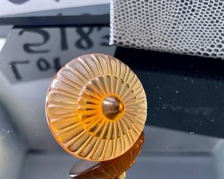 Lot 5183. $70.00ea.  Oh la la! An Amber Lalique "Toupie" Spinning Top, it is signed on the stem. We have 3 of the Amber colored tops, each includes a branded box and string suede bag. 1.25"h x 1.5"w.