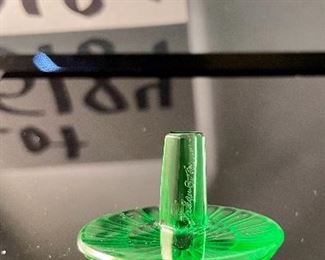 Lot 5184. $70.00.  Oh la la! An Emerald Lalique "Toupie" Spinning Top, it is signed on the stem. We have 1 of the Emerald colored top, includes a branded box and string suede bag. 1.25"h x 1.5"w.