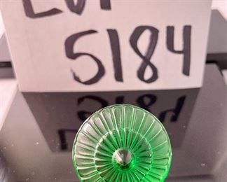 Lot 5184. $70.00.  Oh la la! An Emerald Lalique "Toupie" Spinning Top, it is signed on the stem. We have 1 of the Emerald colored top, includes a branded box and string suede bag. 1.25"h x 1.5"w.