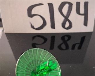 Lot 5184. $70.00.  Oh la la! An Emerald Lalique "Toupie" Spinning Top, it is signed on the stem. We have 1 of the Emerald colored top, includes a branded box and string suede bag. 1.25"h x 1.5"w.