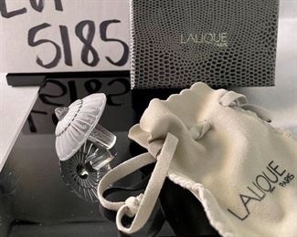 Lot 5184. $70.00.  Oh la la! A clear Lalique "Toupie" Spinning Top, is signed on the stem. We have 1 of the clear tops, includes a branded box and string suede bag. 1.25"h x 1.5"w.