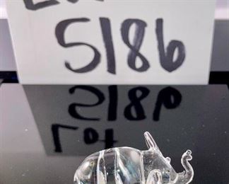 Lot 5186. $90.00. Crystal fun! Swarovski Crystal grape cluster, created as part of the "Sparkling Fruit" theme, faceted clear crystal grapes with gold plated leaves and a stem tip. Swarovski Crystal Strawberry Pin or Pendant with gold-tone leaves, An Unsigned mini elephant, crystal marble, and a trinket tray with a metal palm tree to round out the mix. 