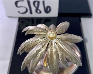 Lot 5186. $90.00. Crystal fun! Swarovski Crystal grape cluster, created as part of the "Sparkling Fruit" theme, faceted clear crystal grapes with gold plated leaves and a stem tip. Swarovski Crystal Strawberry Pin or Pendant with gold-tone leaves, An Unsigned mini elephant, crystal marble, and a trinket tray with a metal palm tree to round out the mix. 