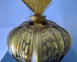 Lot 5190. $225.00. Lalique "Mirabel" Perfume Bottle, in frosted crystal Amber-ish glass. Signed. Brand new, was shrink-wrapped, but we wanted to make sure the markings on the outside matched, the item, so we opened the shrink wrap.  Stunning. Includes Box, outer sleeve, and all insert cards.  1 Mirabel Falcon 11208. Made in France	6"x4.75" roughly