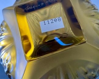 Lot 5190. $225.00. Lalique "Mirabel" Perfume Bottle, in frosted crystal Amber-ish glass. Signed. Brand new, was shrink-wrapped, but we wanted to make sure the markings on the outside matched, the item, so we opened the shrink wrap.  Stunning. Includes Box, outer sleeve, and all insert cards.  1 Mirabel Falcon 11208. Made in France	6"x4.75" roughly