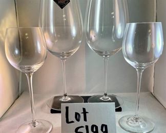 Lot 5199. $72.00. Choose your own adventure wine glasses.  2 substantial Smolleliers Reidel glasses (10.74"t x 3"w at opening) and 2 smaller Reidel (8.25" x 2.5" opening). The smaller glasses have the vintage Reidel Brand on the base. 