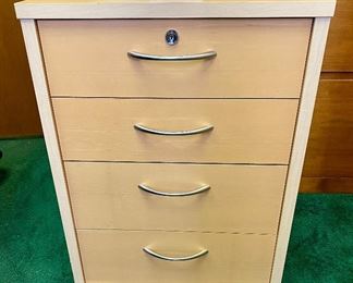 Lot 5205. $95.00 4 Drawer Birch Color Wood Cabinet  w/lock and key on casters. 19" W  x 18" D x 26" H. Very attractive cabinet.