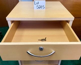Lot 5205. $95.00 4 Drawer Birch Color Wood Cabinet  w/lock and key on casters. 19" W  x 18" D x 26" H. Very attractive cabinet.