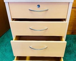 Lot 5205. $95.00 4 Drawer Birch Color Wood Cabinet  w/lock and key on casters. 19" W  x 18" D x 26" H. Very attractive cabinet.