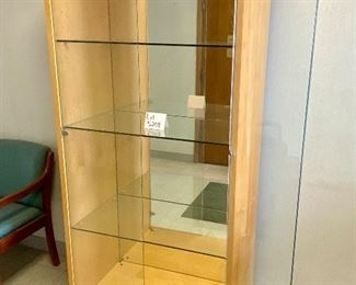 Lot 5208. $850.00. This is truly one beautiful 3 glass shelf Display Case/Curio Cabinet. Birch Wood w/light. Solid Glass doors and Mirror Black. Sits on 4 metal Legs and plenty of display space.  this could work as a Trophy Cabinet, Front Office Display Case or in an Executive Office. 38"W x 19" D x 78" H