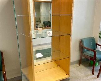 Lot 5208. $850.00. This is truly one beautiful 3 glass shelf Display Case/Curio Cabinet. Birch Wood w/light. Solid Glass doors and Mirror Black. Sits on 4 metal Legs and plenty of display space.  this could work as a Trophy Cabinet, Front Office Display Case or in an Executive Office. 38"W x 19" D x 78" H