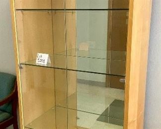 Lot 5208. $850.00. This is truly one beautiful 3 glass shelf Display Case/Curio Cabinet. Birch Wood w/light. Solid Glass doors and Mirror Black. Sits on 4 metal Legs and plenty of display space.  this could work as a Trophy Cabinet, Front Office Display Case or in an Executive Office. 38"W x 19" D x 78" H