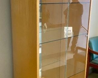 Lot 5208. $850.00. This is truly one beautiful 3 glass shelf Display Case/Curio Cabinet. Birch Wood w/light. Solid Glass doors and Mirror Black. Sits on 4 metal Legs and plenty of display space.  this could work as a Trophy Cabinet, Front Office Display Case or in an Executive Office. 38"W x 19" D x 78" H