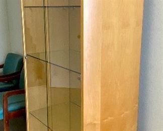 Lot 5208. $850.00. This is truly one beautiful 3 glass shelf Display Case/Curio Cabinet. Birch Wood w/light. Solid Glass doors and Mirror Black. Sits on 4 metal Legs and plenty of display space.  this could work as a Trophy Cabinet, Front Office Display Case or in an Executive Office. 38"W x 19" D x 78" H
