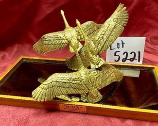 Lot 5221. $75.00. 3 Geese in Flight Brass Sculpture 10"w x 9"d x7"t. The Flight by Gunther R Granget, wood base w/mirror. 1981. Cast with 24 karat gold vermeil over solid American pewter. No box included.	15"w x 7.25"d