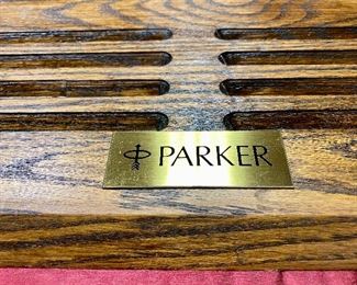 Lot 5223. Parker Display Case, plastic top with wood base.	29.5"w x 11"d x 7"tLot 5223. $175.00. Vintage and Unique Parker Pen Display Case,  Storage for 22 Parker Pen Display with Custom Plexiglas Cover.  Whether you collect pens or resell,  this is a fantastic way to display your pens. The oak base is solid with the Parker placard.   29.5"w x 11"d x 7"t
